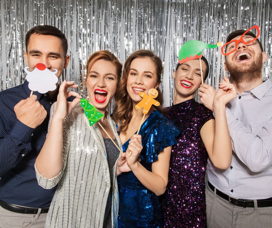 Group of staff with festive masks at a work Christmas party